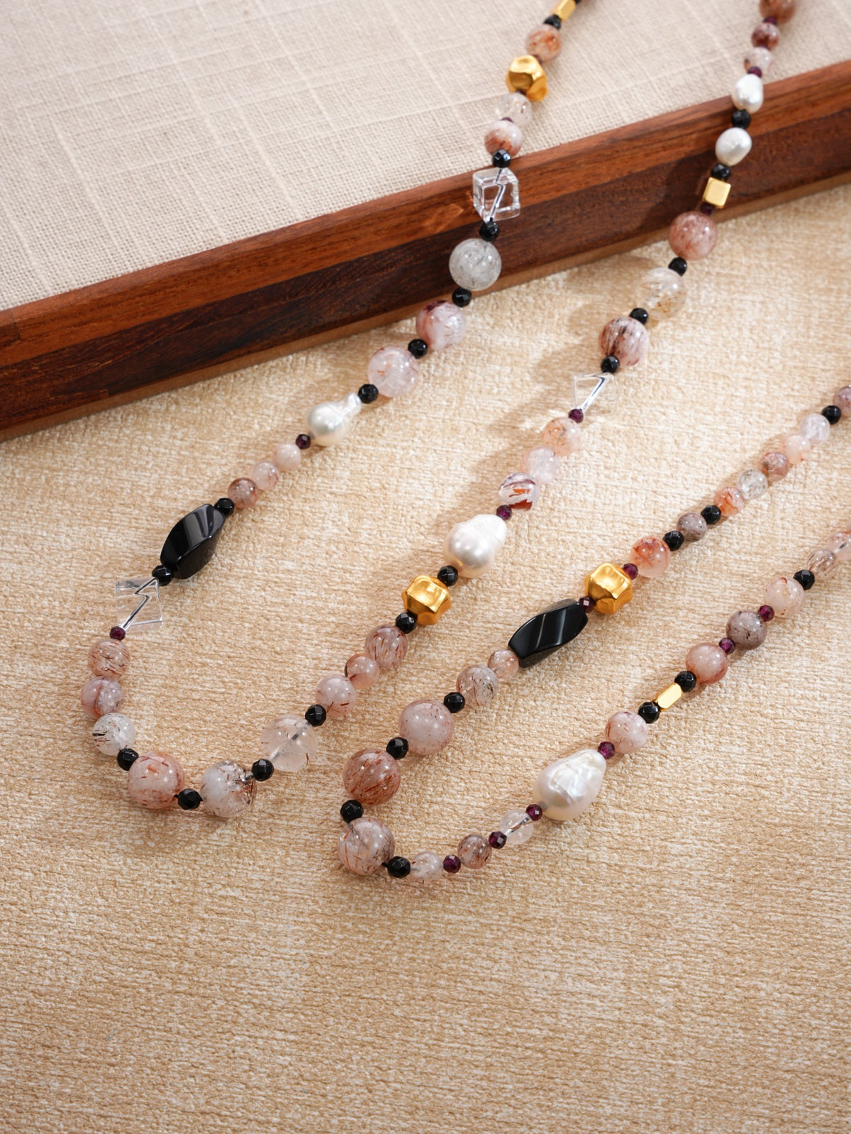 Close-up natural crystal, black stone, baroque pearl and gold-tone necklace details, SKU 260854