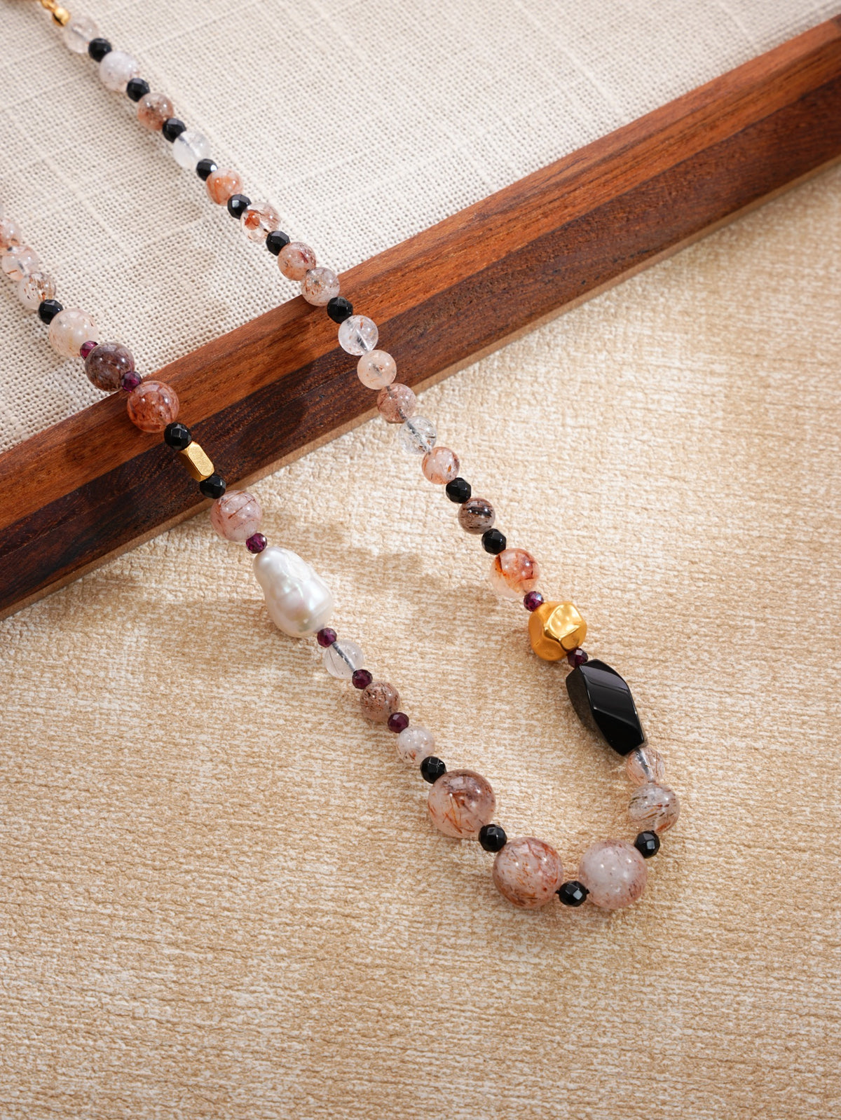 Close-up baroque pearl, natural crystal, black stone and sculptural gold-tone beads, SKU 260854